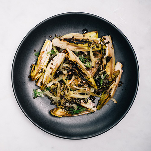 <p>Charring endive and fennel gives texture and flavor to a healthy winter lentil salad while dried prunes add sweetness to counter the sharp edge of the shallot vinaigrette.</p>
